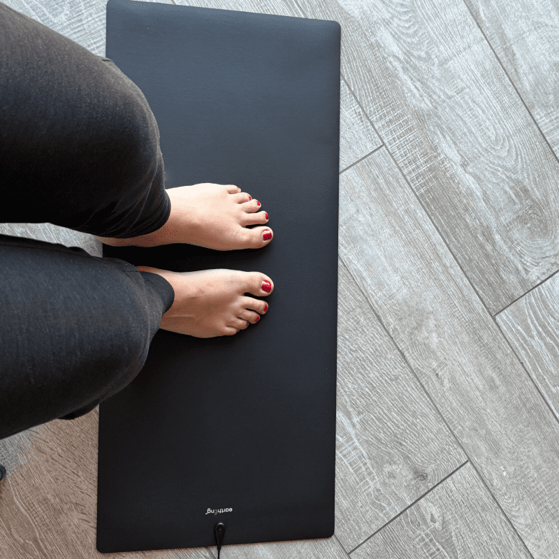 Feet on The Earthing Universal Mat while sitting